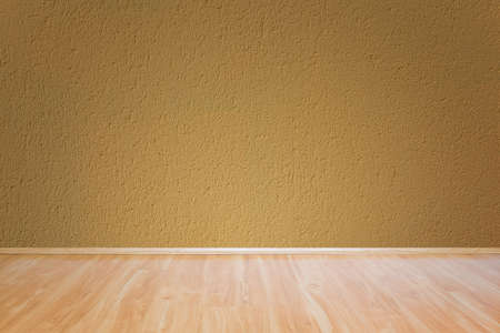 Yellow wall texture and wooden floor backgroundの写真素材