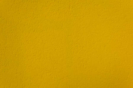 Yellow concrete wall texture close upの写真素材
