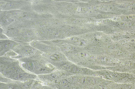 Lagoon water texture with small stones