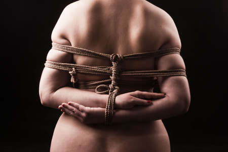 Young submissive woman in japanese bondage takate kote / BDSM themeの写真素材