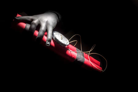 Dynamite bomb with a timer, and a bunch of dynamite on black background. Dynamite is going to explode or detonate per 1 second.の写真素材