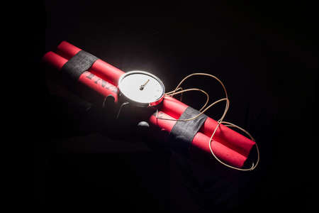 Dynamite bomb with a timer, and a bunch of dynamite on black background. Dynamite is going to...
