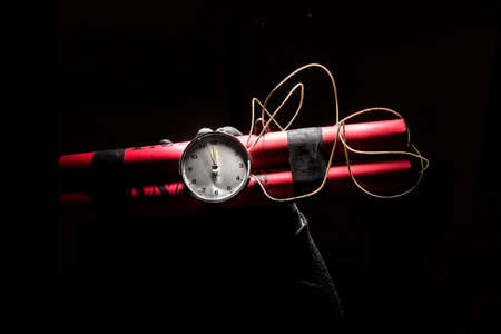 Dynamite bomb with a timer, and a bunch of dynamite on black background. Dynamite is going to...