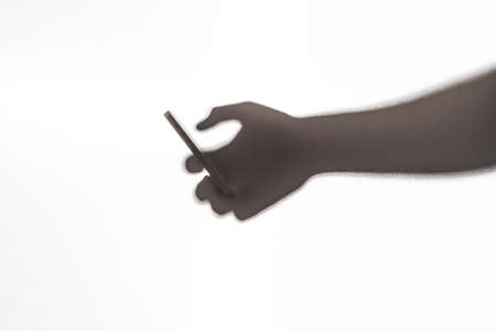 silhouette of hand with smart phone.の写真素材