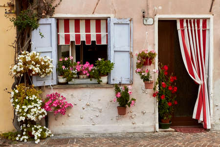 Among the flowery houses of Caorle's cityの写真素材