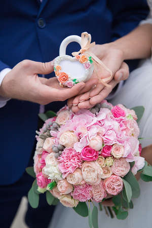 The bride and groom holding a beautiful wedding bouquetの写真素材