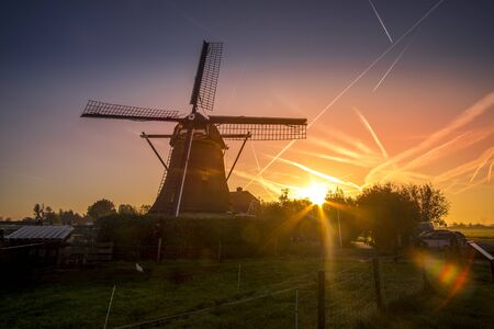 Beautiful sunset in front of windmill, Netherlandsの写真素材