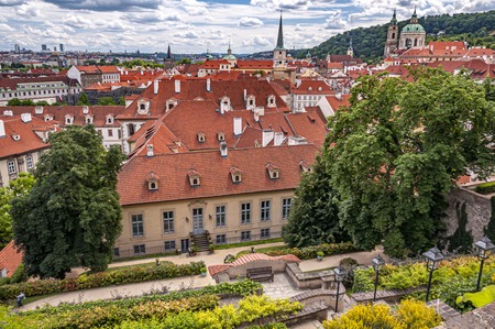 View over red rooftops of Prague from the gardens below Prague Castle in district Lesser Town (Mala Strana) with beautiful clouds. Prague, Czech Republicのeditorial素材