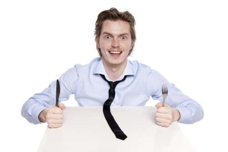 Young man is hungry. Studio shot of hungry man, isolated on white.の写真素材