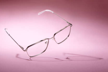 Studio shot of silver glasses at pink background.