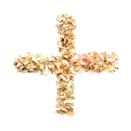 Plus sign made from coloured pencil shavingsの写真素材