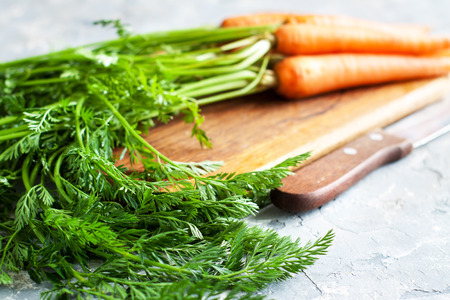 Fresh carrots bunch on stone tableの写真素材
