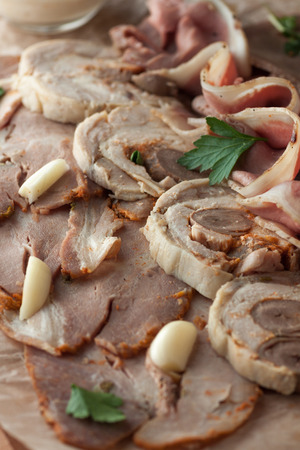 Assorted homemade meat products with mayonnaise sauce on wooden cutting boardの写真素材