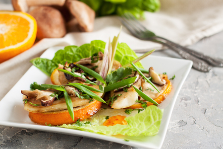 White fish with citrus, ginger and shiitake mushrooms on grey backgroundの写真素材