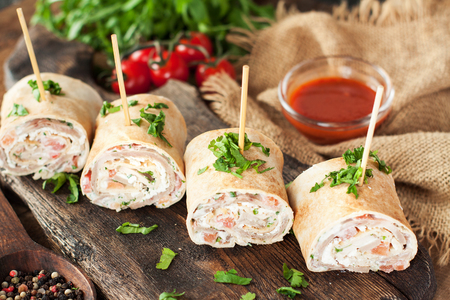 Taco bites with turkey or chicken, cheese, vegetables and fresh herbs. Healthy appetizer rollsの写真素材