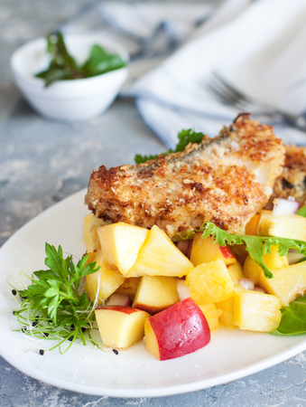 Cod crusted in almond meal and coconut milk served with peach, pineapple, onion and lime salsaの写真素材