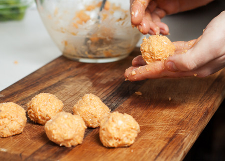 Preparation of fried fish croquettes from canned salmon, egg yolks, onion, coconut butter and spicesの写真素材