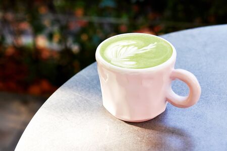 Ceramic cup of matcha latte with beautiful foam on grey background.の写真素材