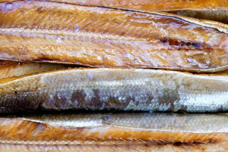 Stack of smoked fish, close up, background