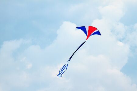Colorful kite in the cloudy sky
