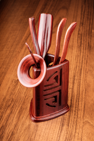 Set of chinese tea tools in stand with traditional style pattern on wooden deskの写真素材