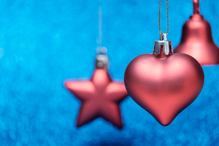 Small red Christmas toys on glitter background. Merry Christmas and Happy New Year cardの写真素材