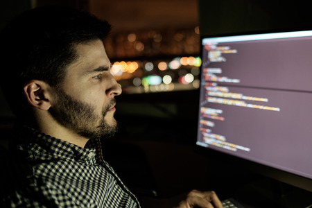 Software developer computer at dark home office. Startup and hard working conceptの写真素材