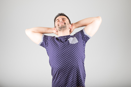 Man stretching after wake up isolated over gray backgroundの写真素材