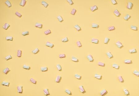 Sweet marshmallows minimalism set on pastel straw yellow backgroundの写真素材