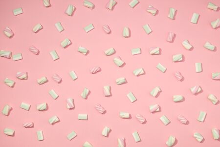 Sweet marshmallows minimalism set on pastel rose petal backgroundの写真素材