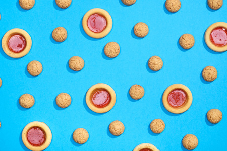 Pattern made of sweet cookies on blue background. Flat layの写真素材