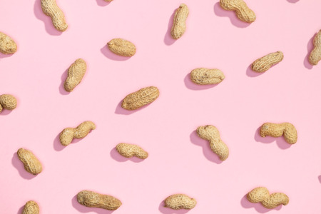 Peanut random flat lay pattern on pink backgroundの写真素材