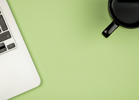 High angle view of office colored desk with copy space. Table with laptop and supplies. Top view. Flat lay. Freelancer or student deskの写真素材