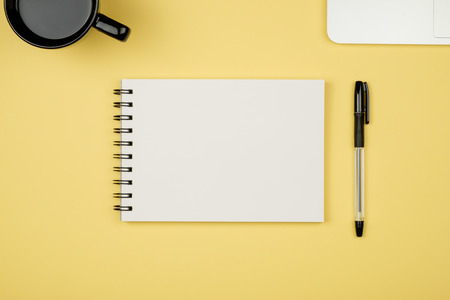 Top view flat lay picture with blank notepad page and different accessories on colored surfaceの写真素材