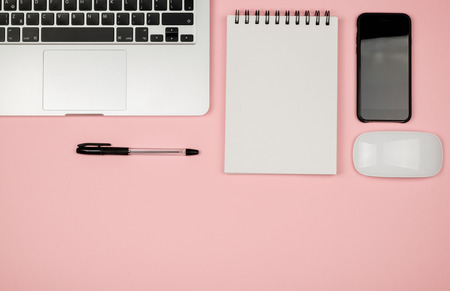 Minimal workplace with notebook and copy space on pastel background. Top view. Flat lay.の写真素材