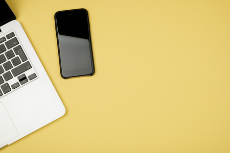 Minimal workplace with notebook and copy space on pastel background. Top view. Flat lay.の写真素材