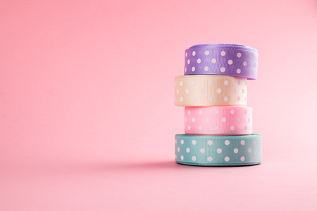 Closeup of ribbon roll over colorful background isolatedの写真素材
