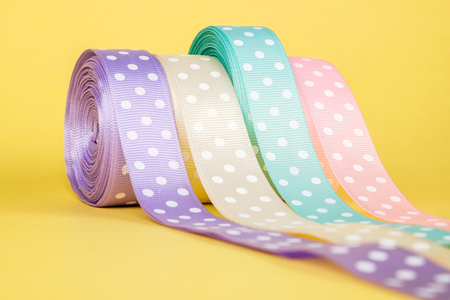 Closeup of ribbon roll over colorful background isolatedの写真素材