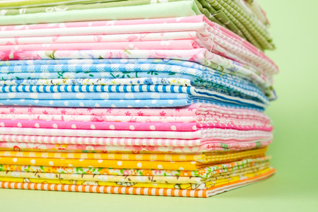 Pile of colorful cloth over colorful background isolated