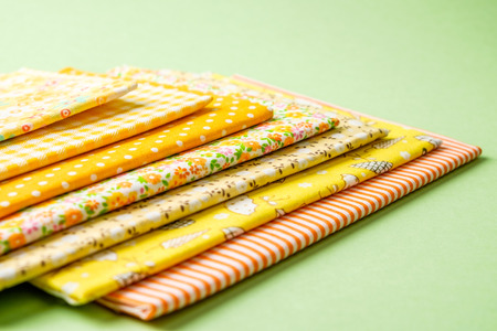 Pile of colorful cloth over colorful background isolatedの写真素材