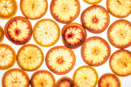 Bright red orange slices. Juicy transparent fruit on white luminous backgroundの写真素材