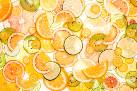 Sliced citrus fruits background. Grapefruit, orange, lemon, lime, kumquat, kiwi, mandarinの写真素材