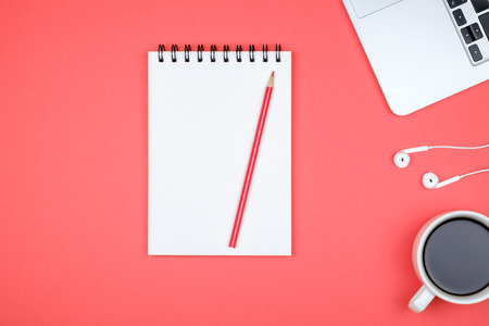 Modern designer office desk table with blank notebook page, laptop computer and cup of coffee. Top view, flat layの写真素材