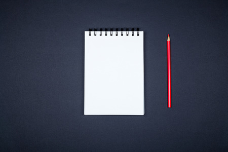 Top view of open spiral blank notebook on colorful desk backgroundの写真素材