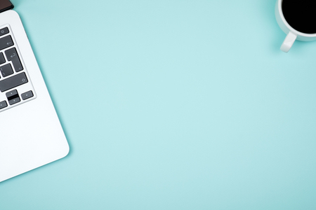 Blue office desk table with computer. Top view with copy spaceの写真素材