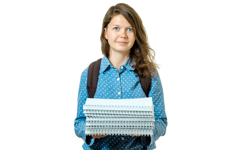 Portrait of young student girl with books and backpack isolated on white background