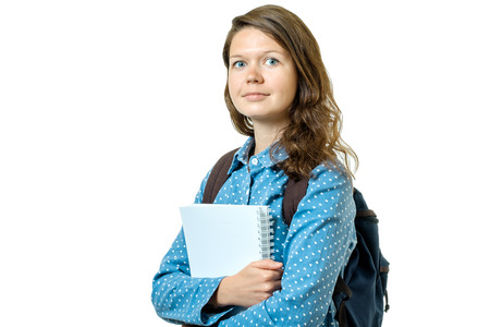 Portrait of young student girl with books and backpack isolated on white backgroundの写真素材