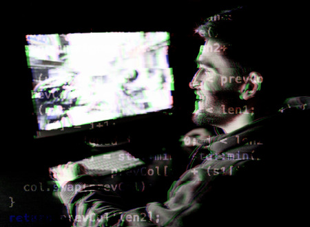 Young man playing computer games online. Digital glitch effect addedの写真素材