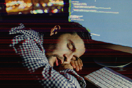 Man working with computer. Program development concept. Glitch effect addedの写真素材