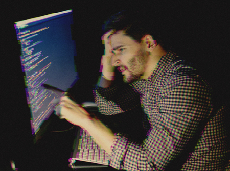 Man working with computer. Program development concept. Glitch effect added